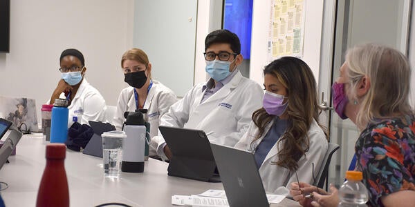 students listening to an instructor prior to a doctoring course