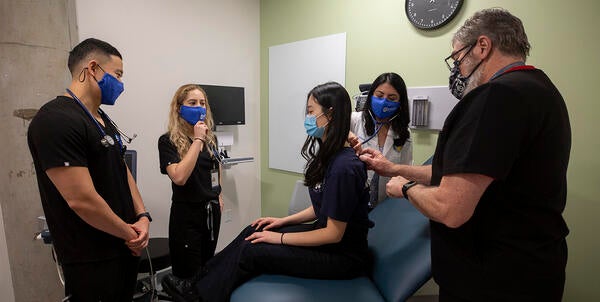 Students learning in mock exam room