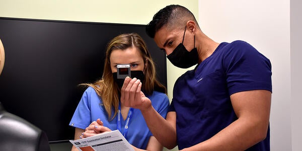 Doctor and medical student looking at a slide during ocular exam lesson